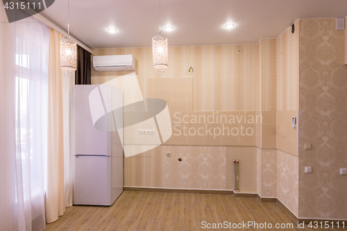 Image of Interior of an empty kitchen without furniture, in studio apartment