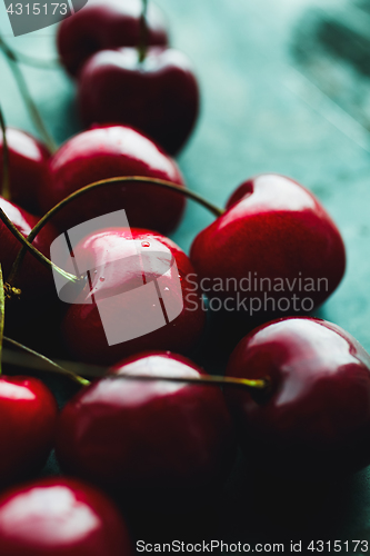 Image of Ripe cherries on green