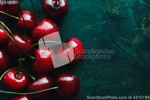 Image of Ripe cherries on green