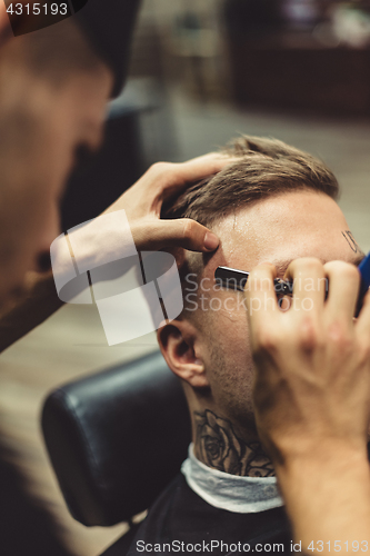 Image of Crop stylist shaving client