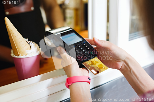 Image of Person paying bill in cafe