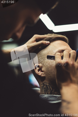 Image of Crop stylist shaving client