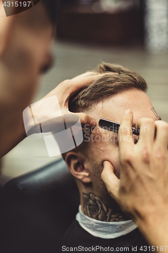 Image of Crop stylist shaving client