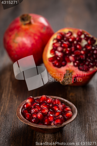 Image of Pomegranate fruit on wooden vintage background