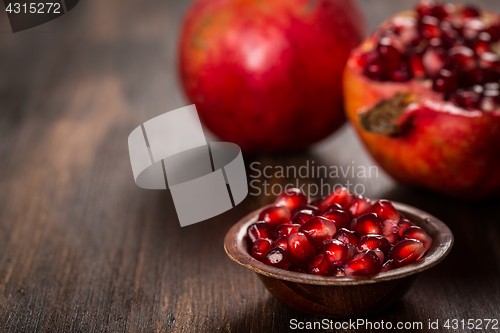 Image of Pomegranate fruit on wooden vintage background