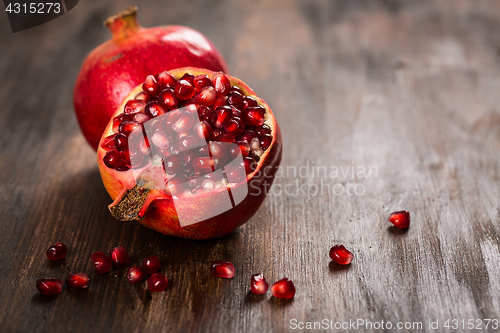 Image of Pomegranate fruit on wooden vintage background