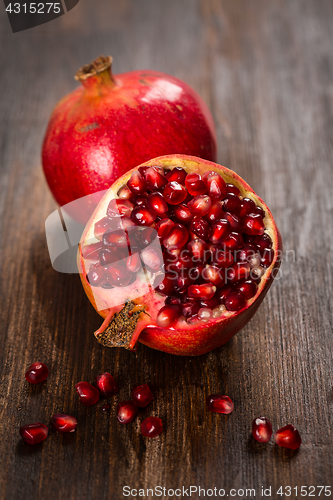 Image of Pomegranate fruit on wooden vintage background