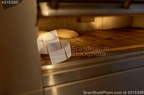 Image of yeast bread dough in oven at bakery kitchen