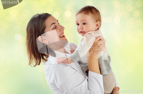 Image of happy woman doctor or pediatrician with baby