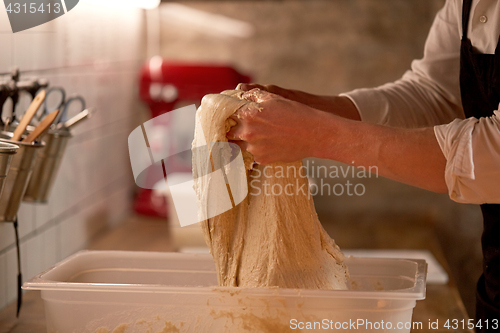 Image of chef or baker cooking dough at bakery