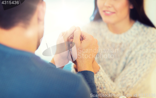 Image of happy couple holding hands at restaurant or cafe