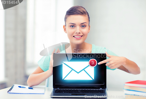 Image of smiling student girl with laptop at school