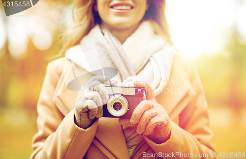 Image of close up of woman with camera in autumn park