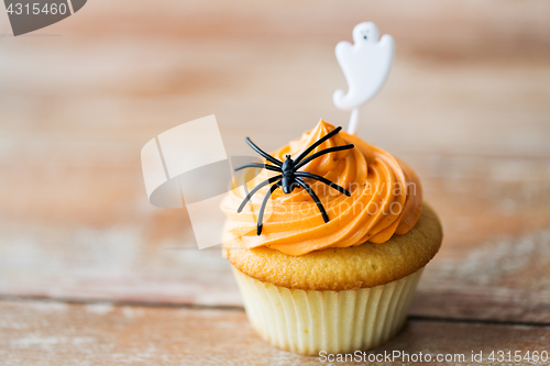 Image of cupcake with halloween decoration on table