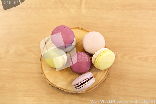 Image of different macarons on wooden stand