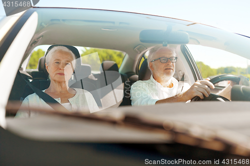 Image of happy senior couple driving in car