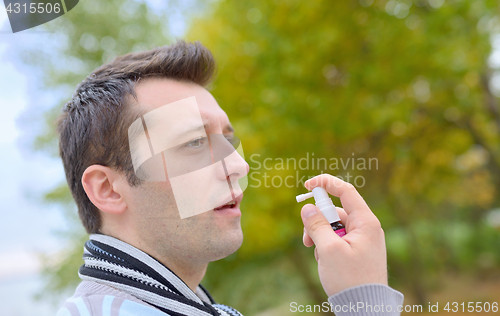 Image of Man spraying with nasal spray