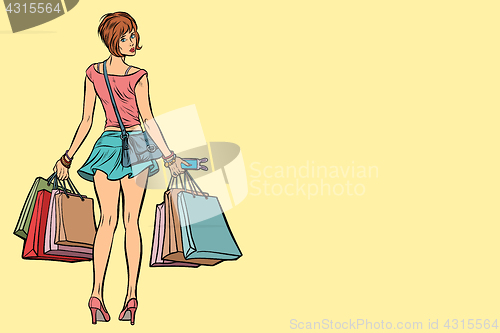 Image of Young woman with shopping bags on sale