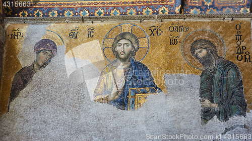 Image of 13th century Deesis Mosaic of Jesus Christ flanked by the Virgin Mary and John the Baptist in the Hagia Sophia temple in Istanbul, Turkey.