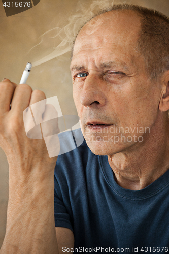 Image of Worried mature man sitting at studio