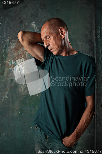 Image of Worried mature man standing at studio