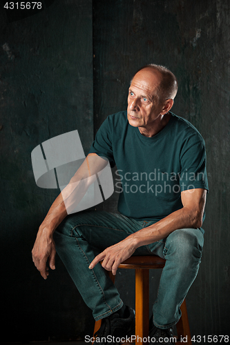 Image of Worried mature man sitting at studio