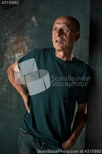 Image of Worried mature man standing at studio