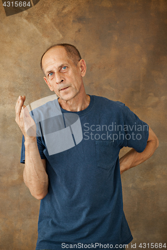 Image of Worried mature man standing at studio
