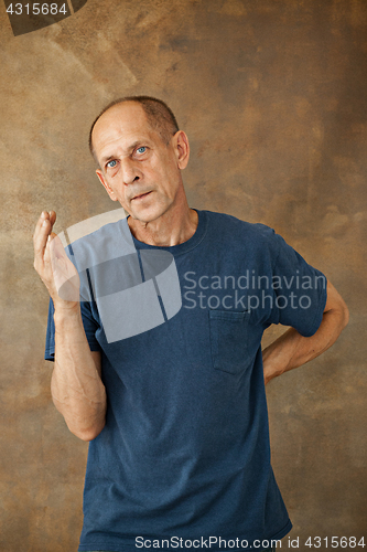 Image of Worried mature man standing at studio