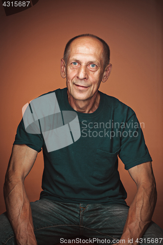 Image of Worried mature man sitting at studio