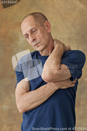 Image of Worried mature man touching his head.