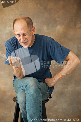 Image of Worried mature man sitting at studio