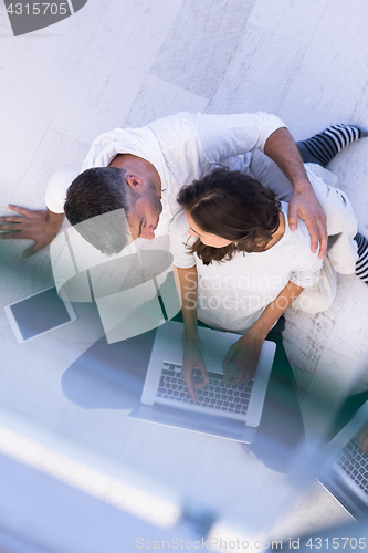 Image of couple using tablet and laptop computers top view