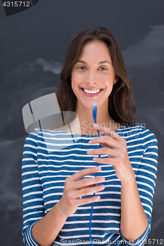 Image of woman holding a internet cable in front of chalk drawing board