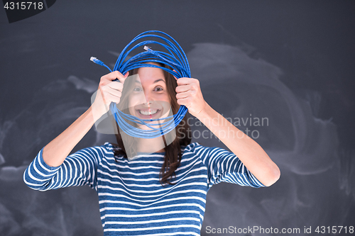 Image of woman holding a internet cable in front of chalk drawing board