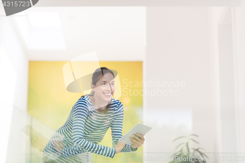 Image of young woman at home websurfing