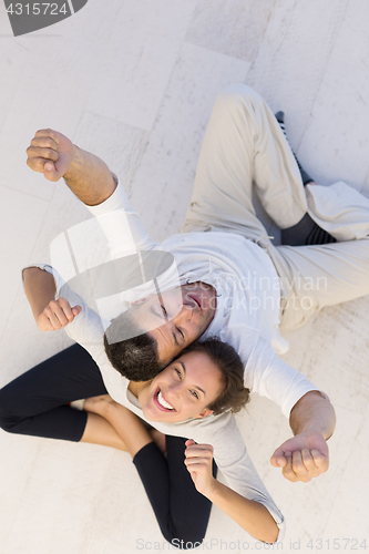 Image of couple sitting with back to each other on floor