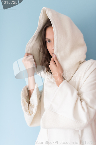 Image of woman in a white coat with hood isolated on blue background