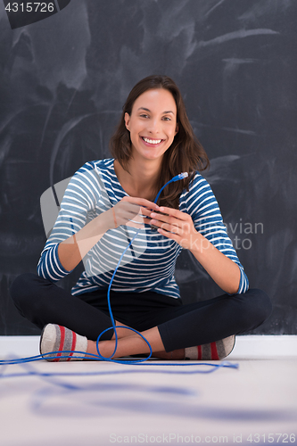 Image of woman holding a internet cable in front of chalk drawing board