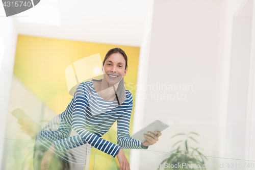 Image of young woman at home websurfing