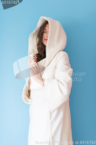 Image of woman in a white coat with hood isolated on blue background