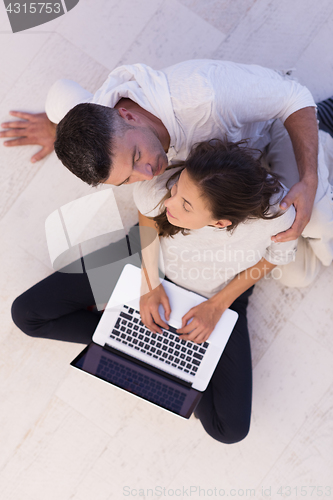 Image of couple using tablet and laptop computers top view