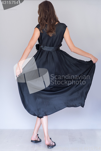 Image of woman in a black dress isolated on white background