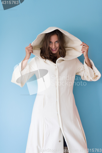 Image of woman in a white coat with hood isolated on blue background