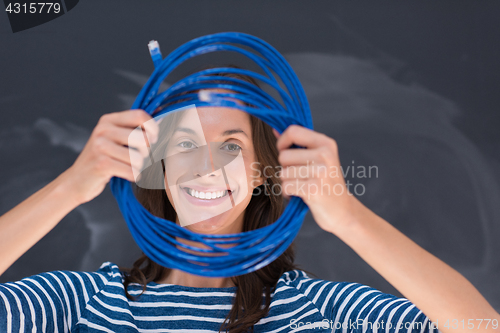 Image of woman holding a internet cable in front of chalk drawing board
