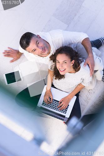 Image of couple using tablet and laptop computers top view