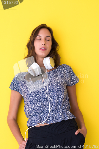Image of woman with headphones isolated on a yellow
