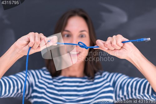 Image of woman holding a internet cable in front of chalk drawing board