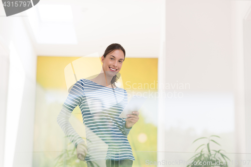 Image of young woman at home websurfing