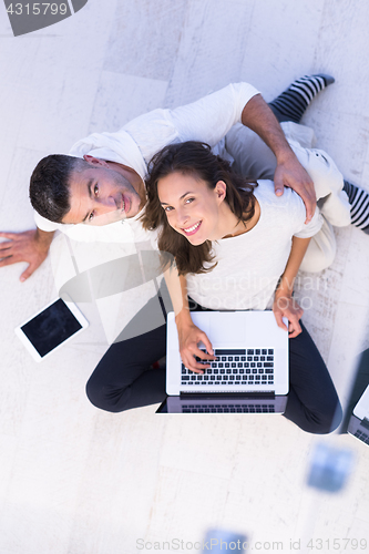 Image of couple using tablet and laptop computers top view